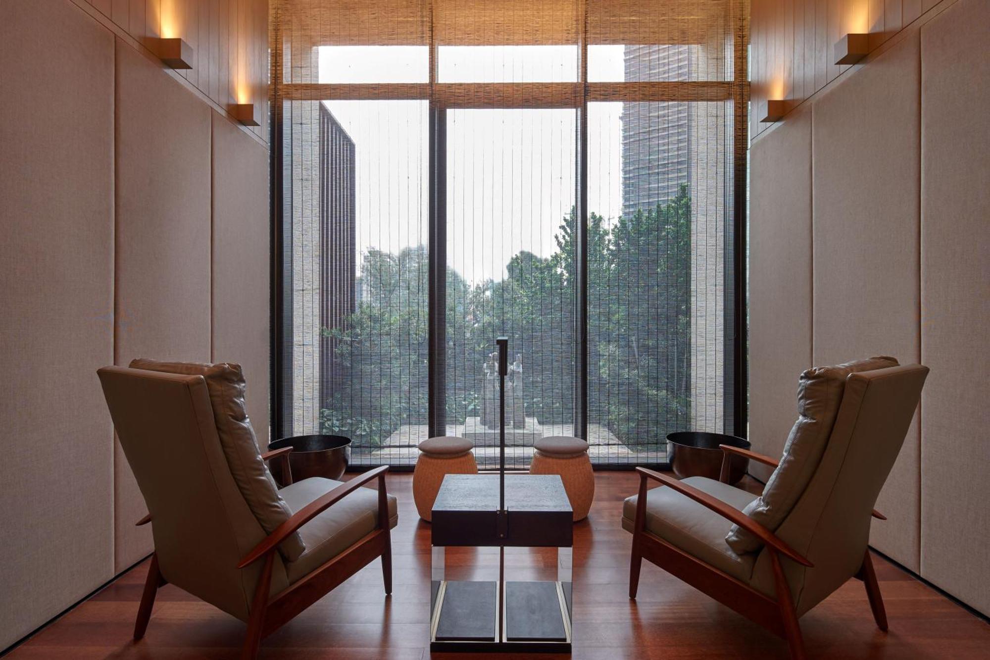 The Ruma Hotel And Residences Kuala Lumpur Kültér fotó The photo depicts a minimalist interior space, featuring two stylish chairs positioned across from each other. Between them, there's a sleek table with a simple design. The walls are finished with a light color, contributing to a serene ambiance. Lar